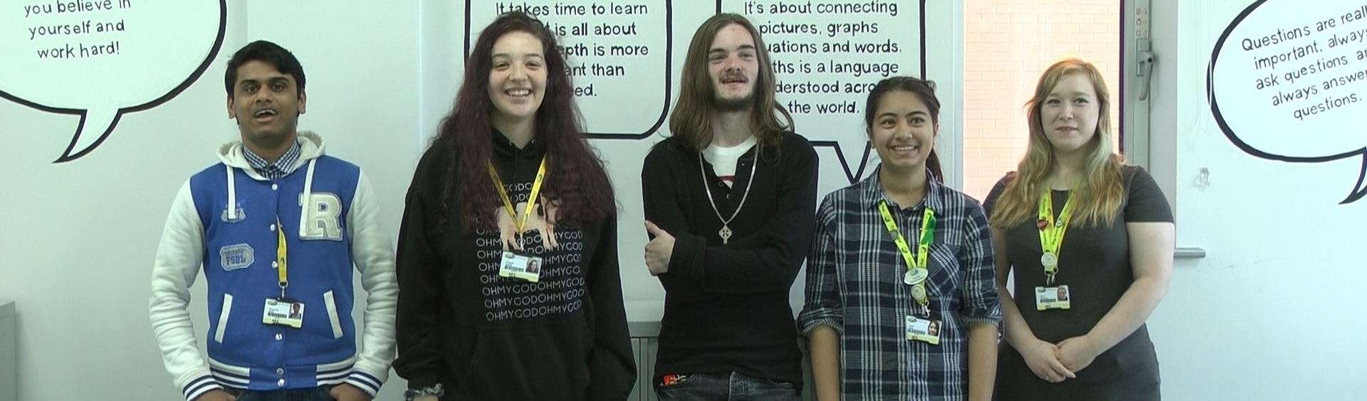 Five WMC English students standing inside classroom