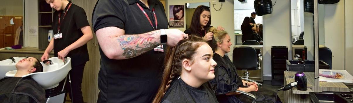 WMC Dressing and Styling Hair students working inside classroom