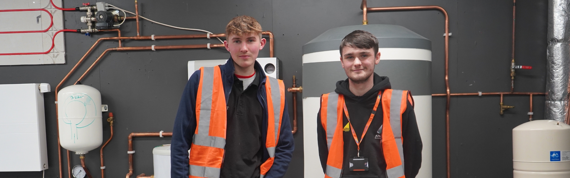 Two Wirral Met apprentices standing together inside work environment