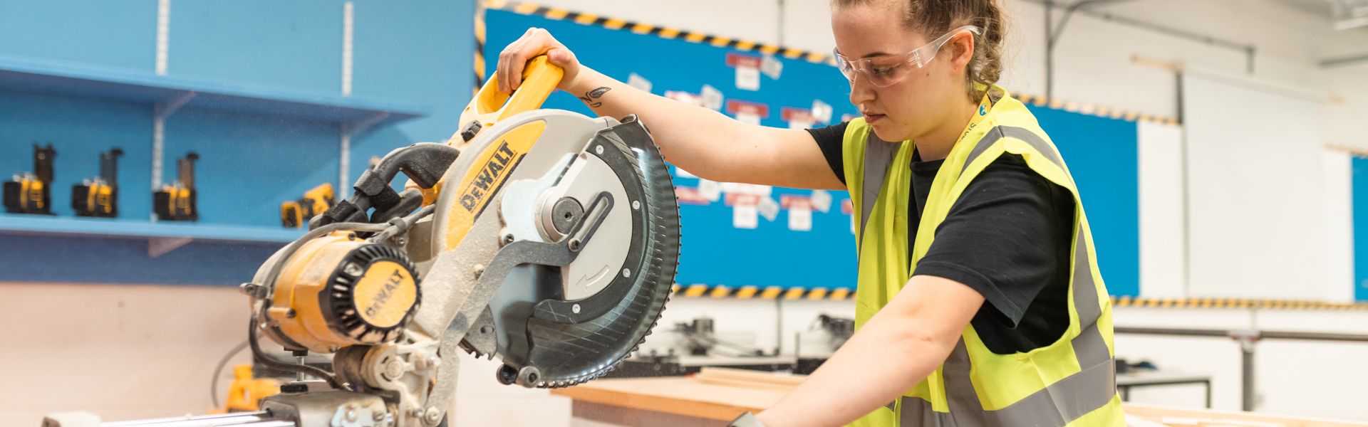 Wirral Met Carpentry and Joinery apprentice uses buzz saw in workshop.