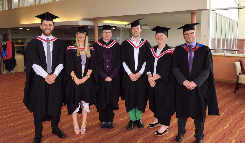 Wirral Met Higher Education Graduates standing in the Floral Pavillion