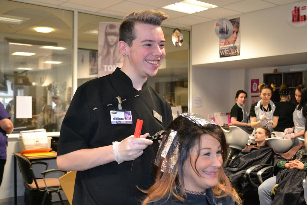 Wirral Met Hairdressing student peforming on a female client's hair