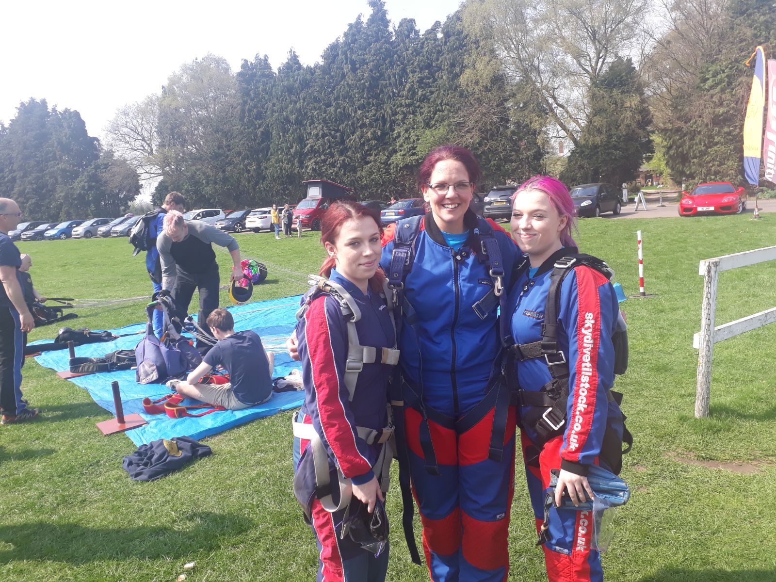 three Wirral Met Childcare students wearing skydiving uniforms 