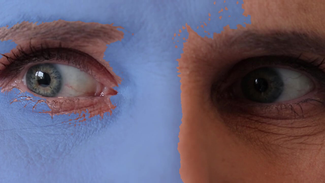 Close up of eyes with the left hand side covered in blue