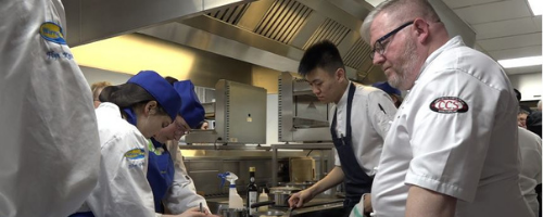 Chef Paul Askew teaching trainee chefs