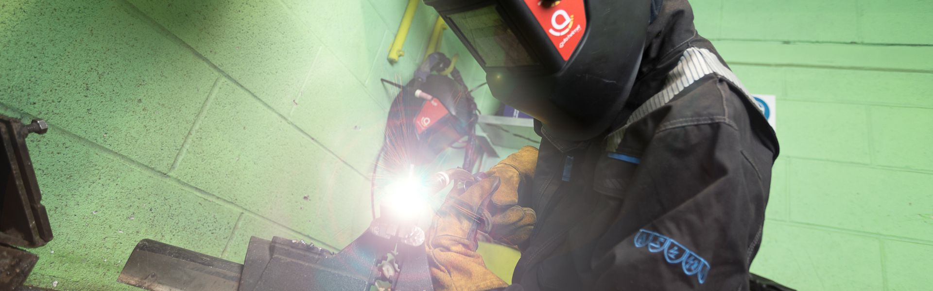 Aspiring Shipbuilding student welding inside of Engineering workshop