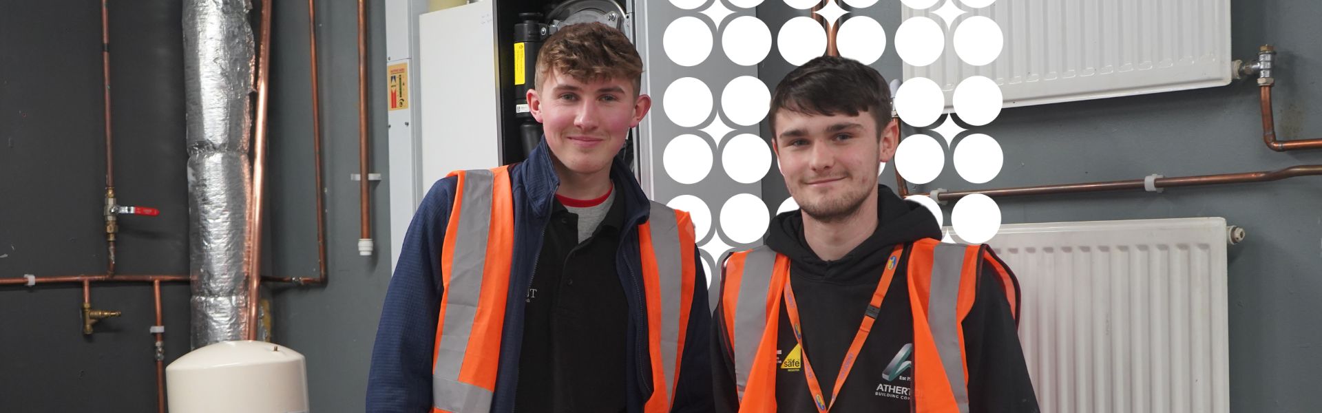 Two plumbing and gas apprentices stood at their workplace