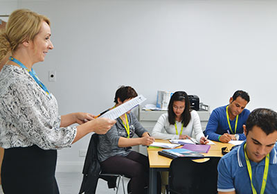 Female Teaching And Assessing CPD Student Teaching A Class Of Students