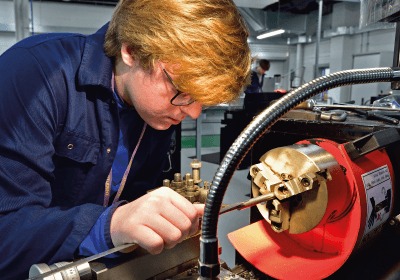 Male Part Time Engineering Student Working In Workshop