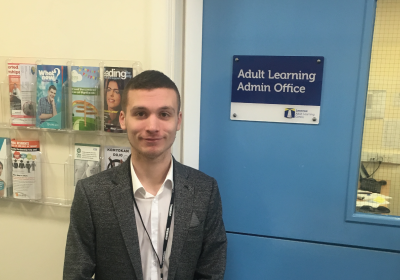 Male Skills For Life And Work Part Time Student Standing Outside Adult Learning Admin Office