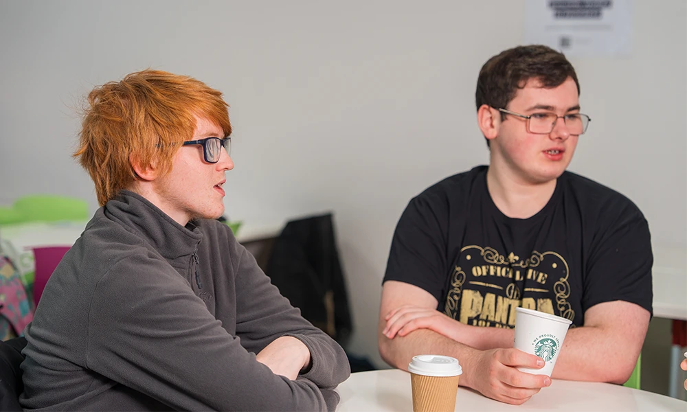 Hair and Beauty students speaking with each other outside of the Library and Study Zone at Conway Park