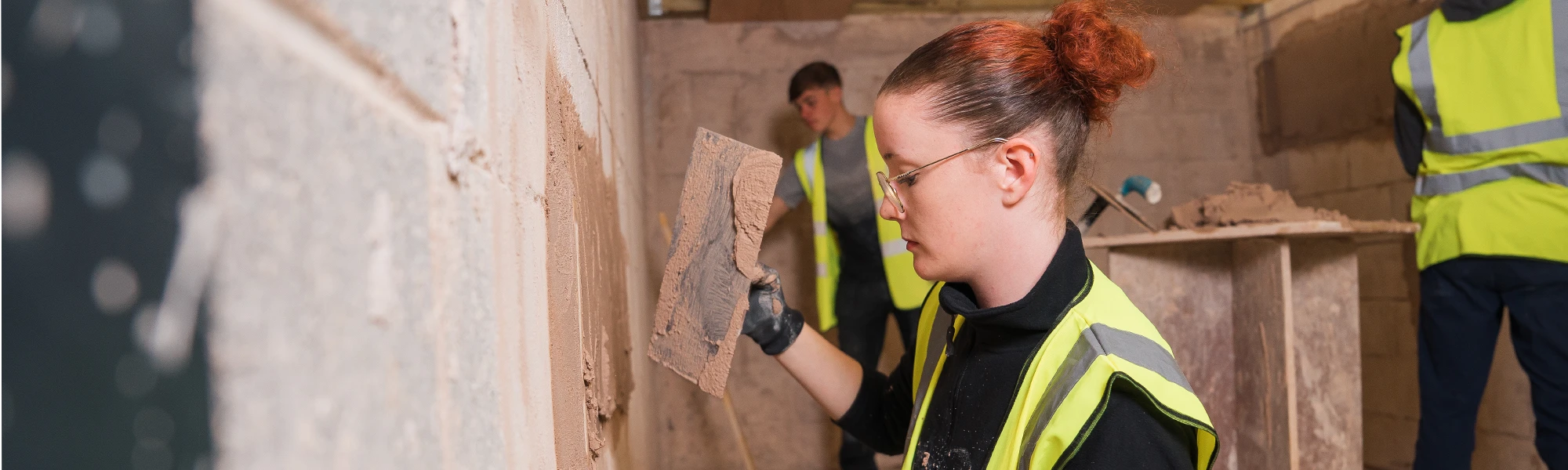Woman Plastering a wall