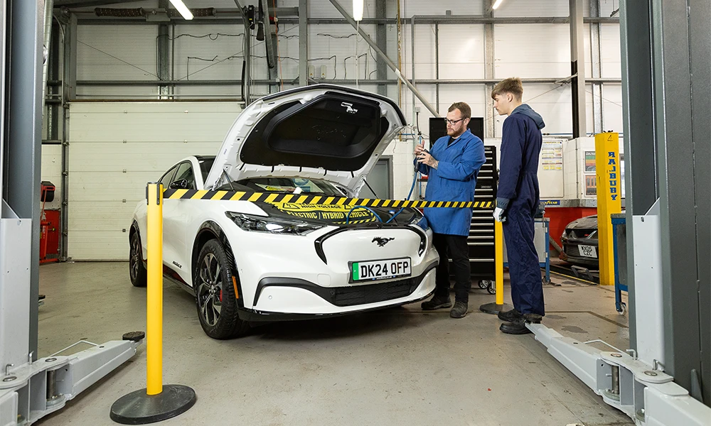 Student and tutor working inside Automotive workshop