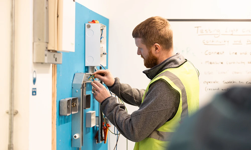 Electrical Installation student working inside Wirral Waters workshop