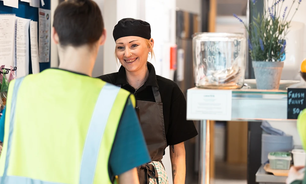 Woman standing in front of a food counter
