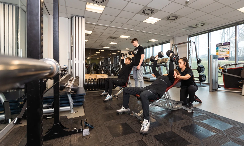 Several students at the Oval campus exercising inside of the gym