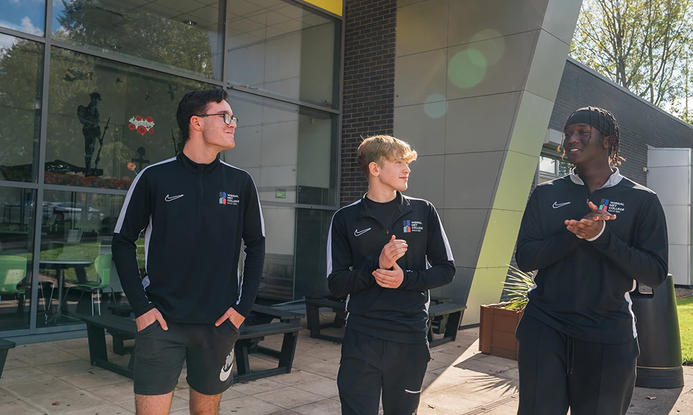 Three sports students stood outside of The Oval campus