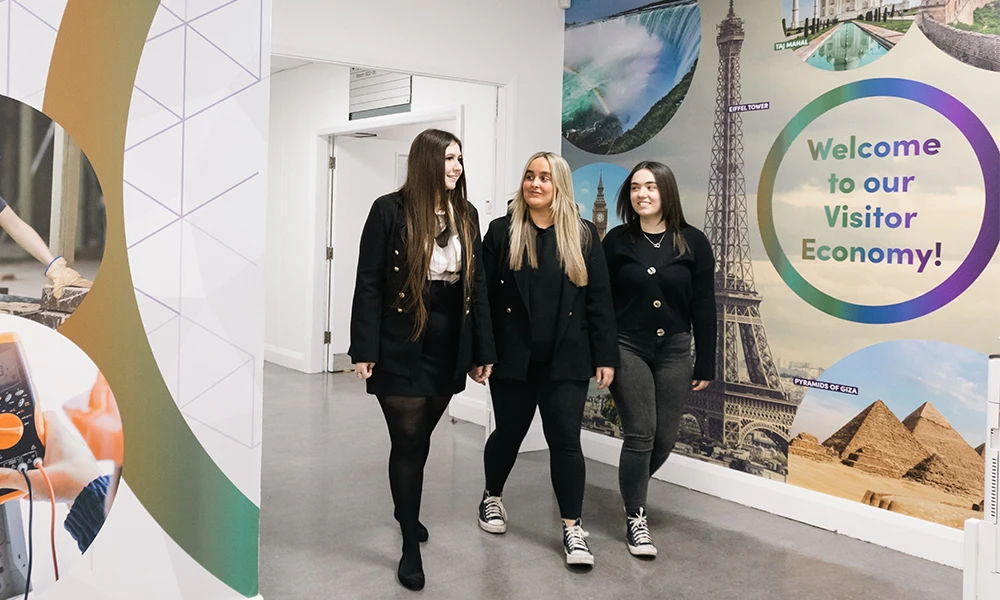 Three Travel and Tourism students walking down corridor at Conway Park