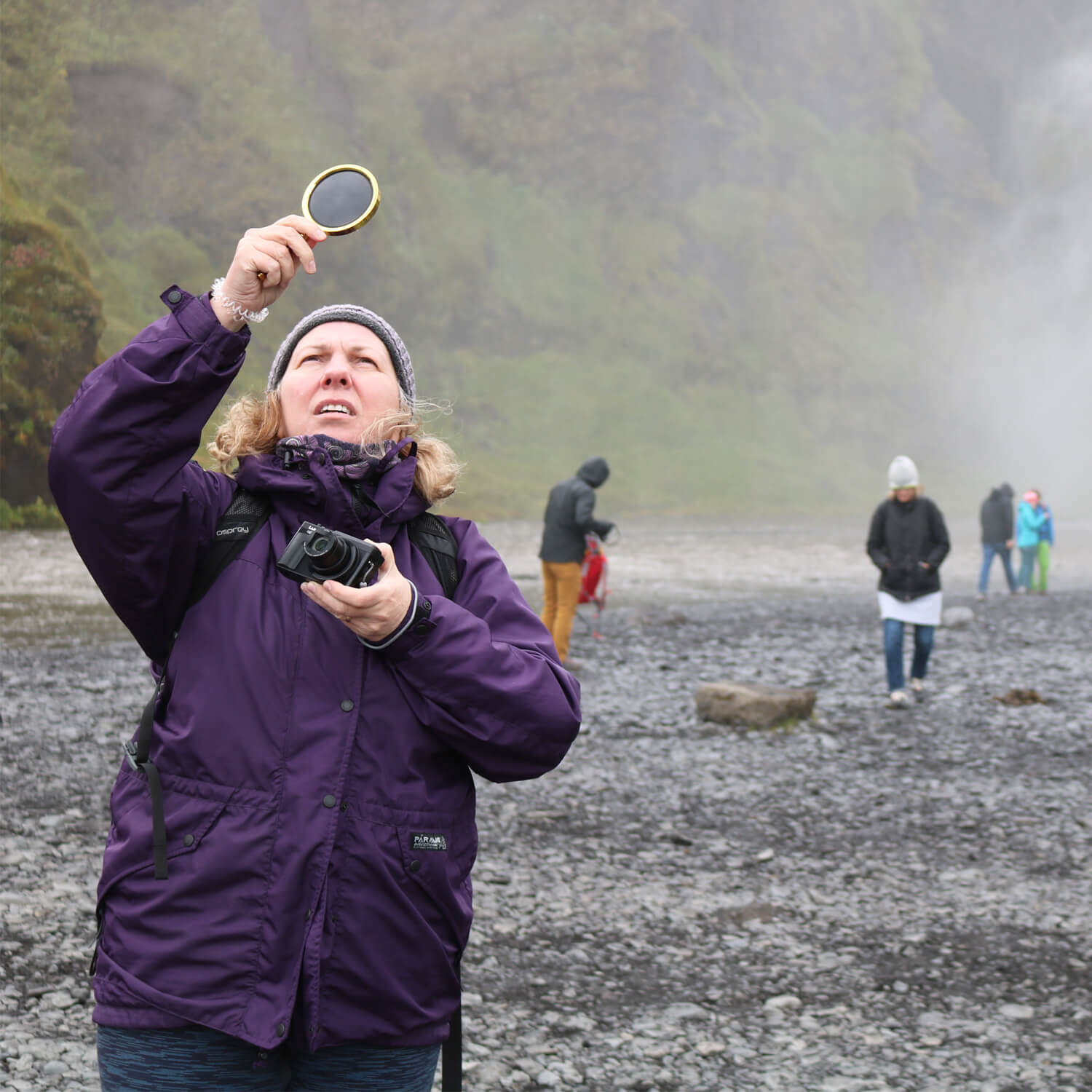Fine Art Degree Student Sally Weaver Exploring Icelandic Waterfall With Magnifying Glass